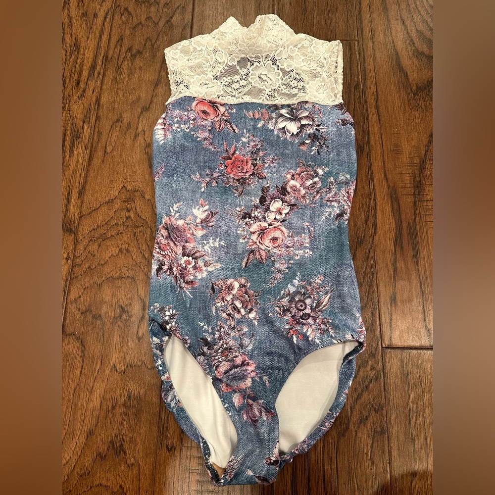 Eleve leotard features a high neck in size x-small.